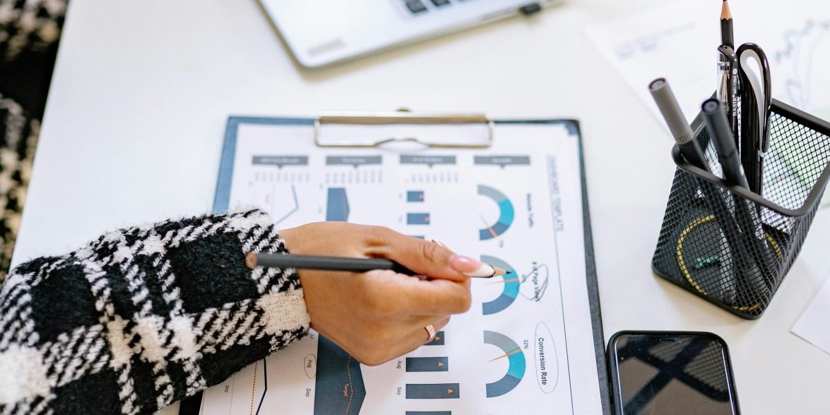 A person in a professional setting, carefully evaluating investment options and metrics for potential AI companies.
