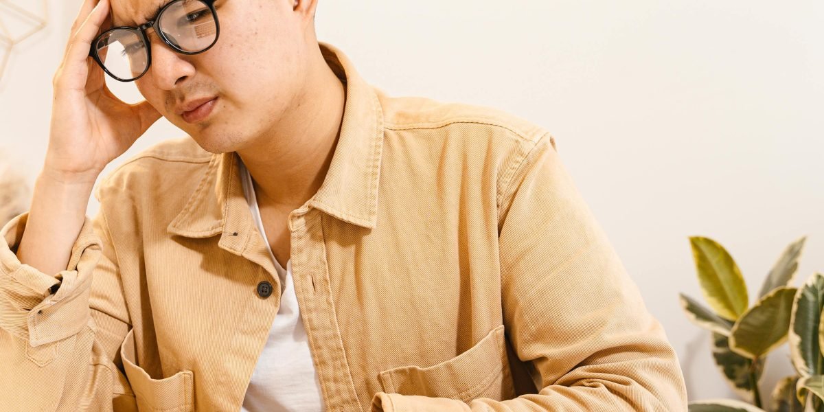 A person contemplating complex information, symbolizing the challenge of navigating the rapidly evolving AI landscape.
