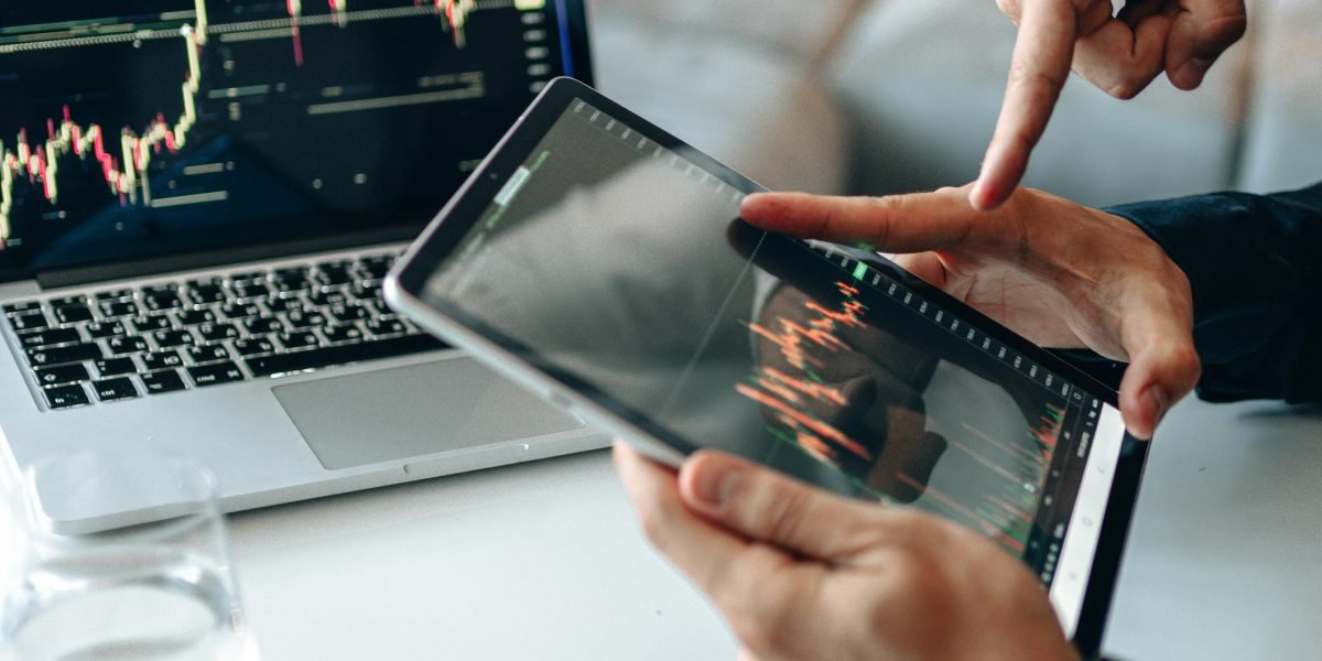 Investors collaborating to identify and discuss emerging market trends and opportunities.