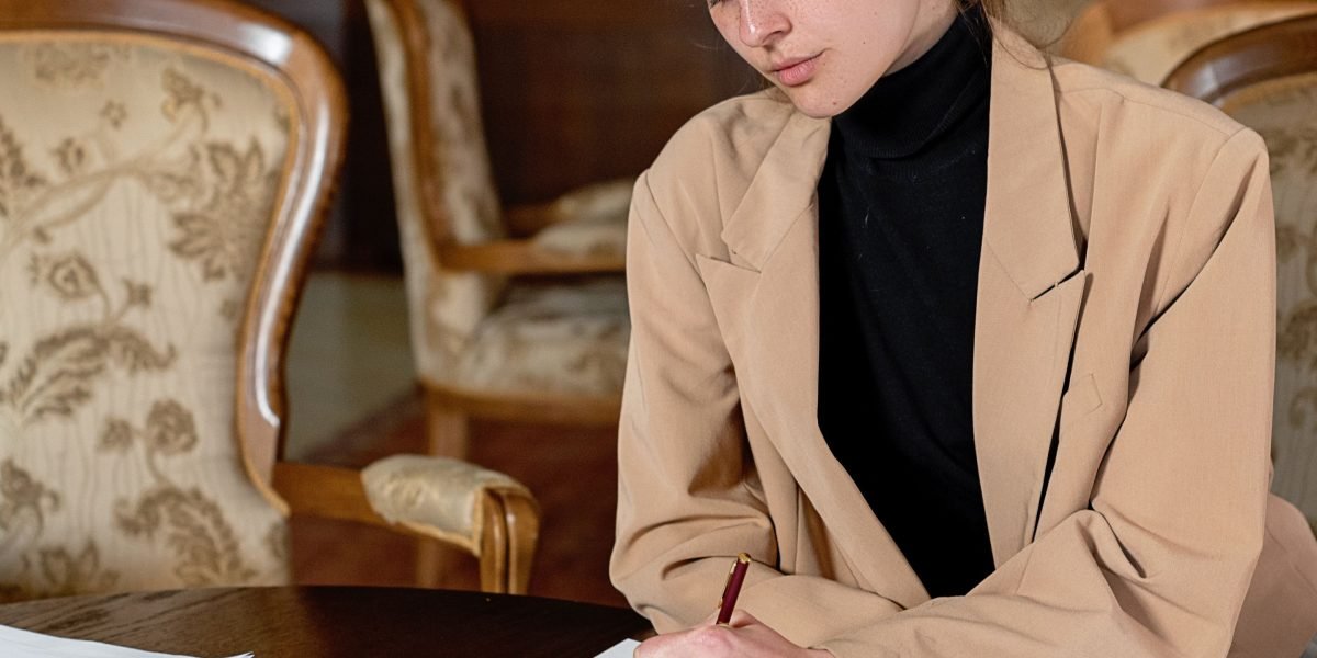 An individual diligently working on crafting a professional resume or cover letter.