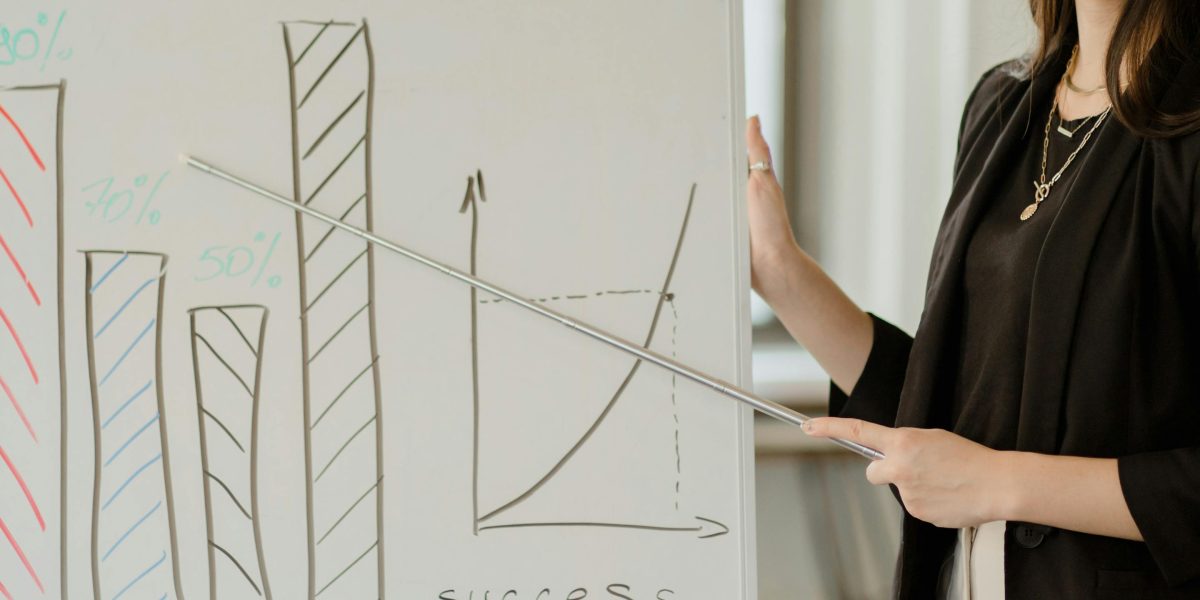 A person actively sketching out career development plans on a whiteboard, symbolizing proactive future-proofing.