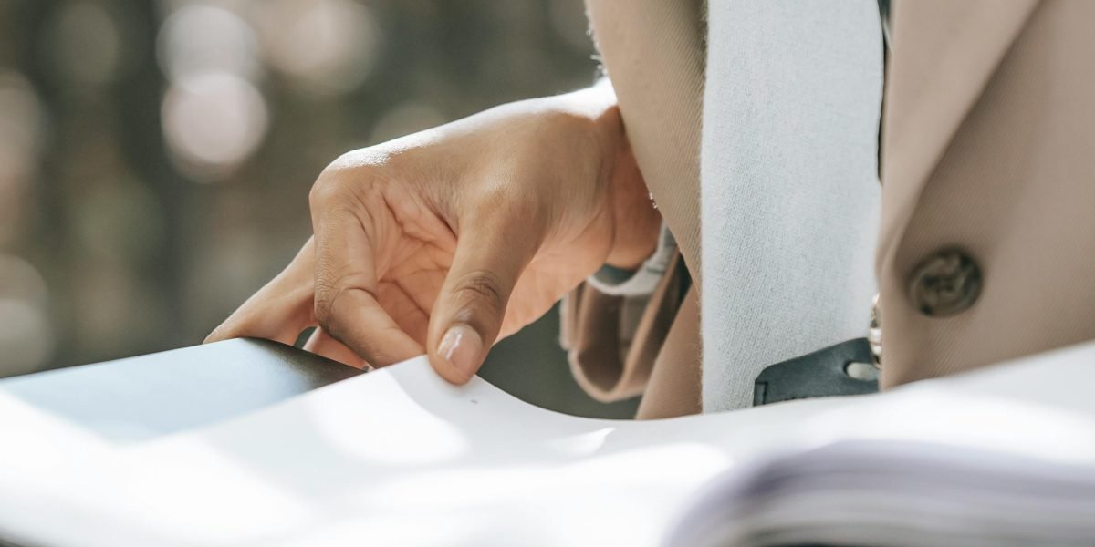 An individual deeply focused on reviewing documents, symbolizing the effort to extract valuable insights from a flood of information.