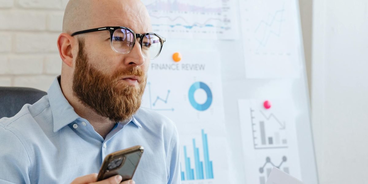 A focused analyst intently reviewing financial data, symbolizing the process of identifying patterns and red flags in business reports.