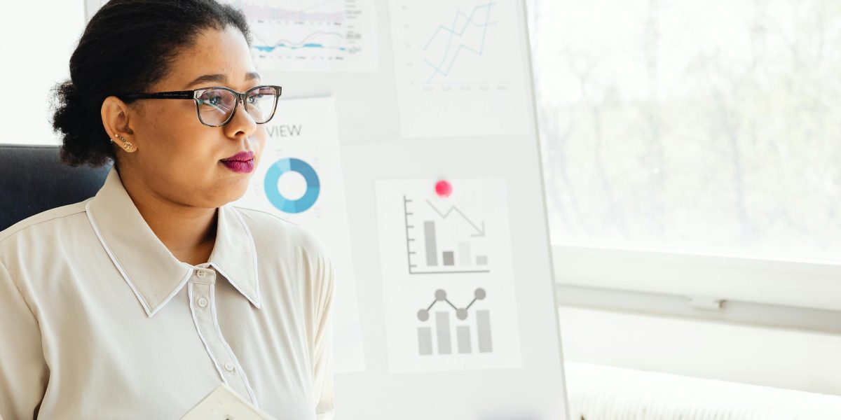 A person looking intently at multiple screens, symbolizing the challenge of information overload in the fast-paced AI world.