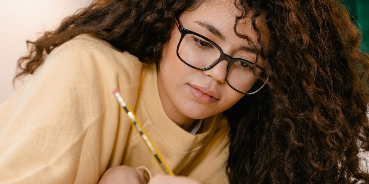An individual engaged in deep, focused study or problem-solving, reflecting the rigorous nature of university programs and MOOCs.
