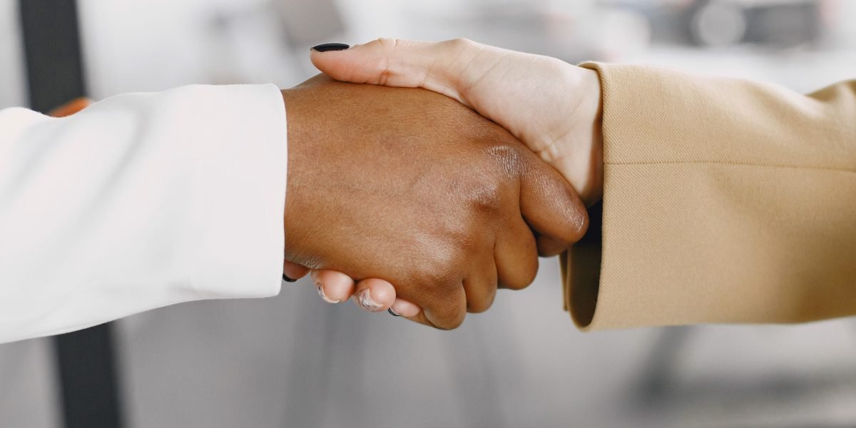 A successful meeting concluding with a handshake, symbolizing new investment and partnership in Michigan's startup scene.