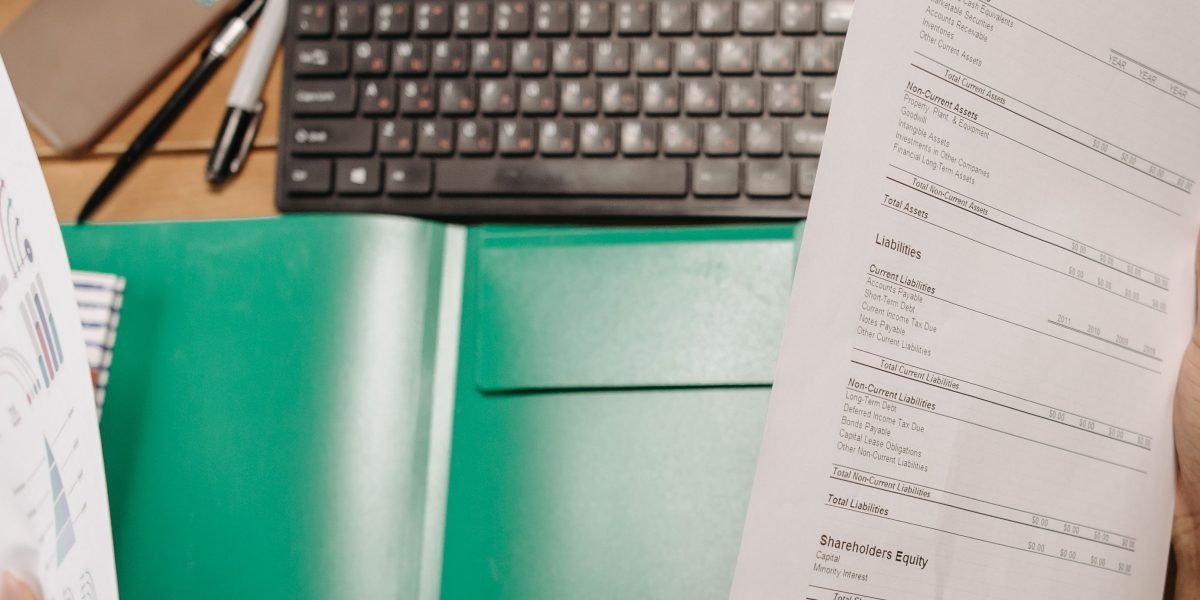 A person intently reviewing business documents, symbolizing the deep due diligence required for AI startup evaluation.