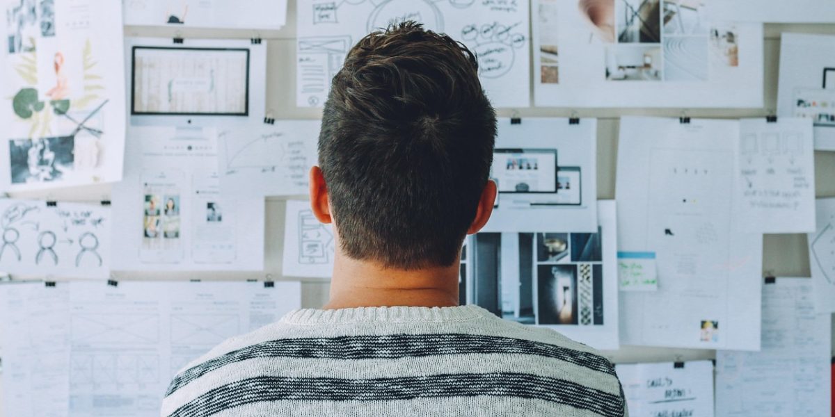 A diverse team actively brainstorms and discusses new investment opportunities, utilizing data tools for deal sourcing.