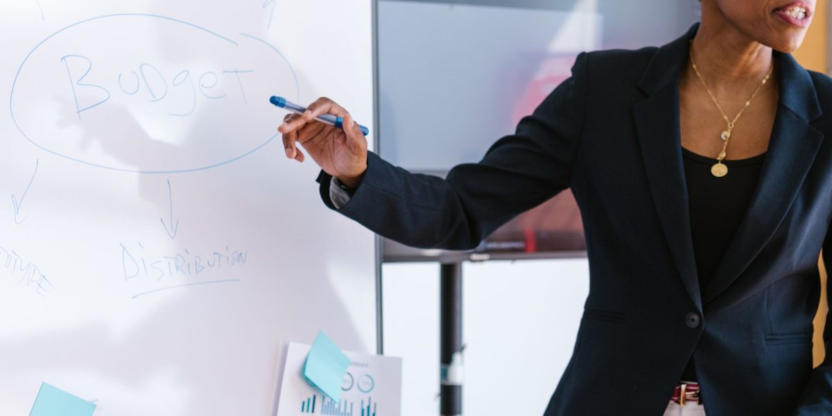 An entrepreneur confidently presenting a business idea to a panel of investors, demonstrating effective communication and pitching skills.