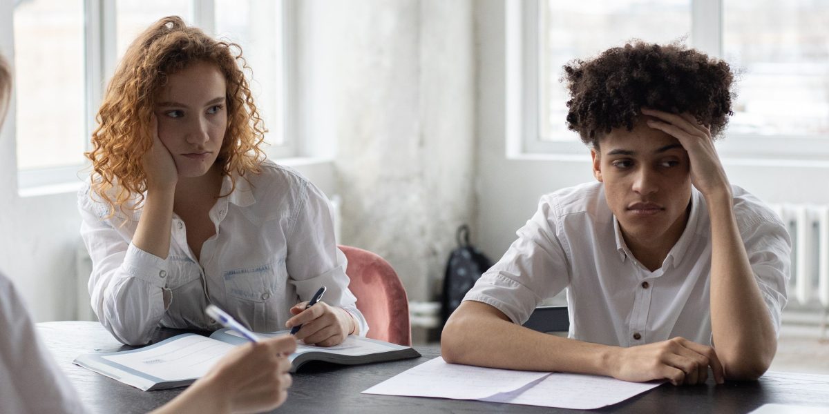 A group of diverse individuals engaged in a serious discussion, representing varied public concerns about the implications of new technologies like AI.