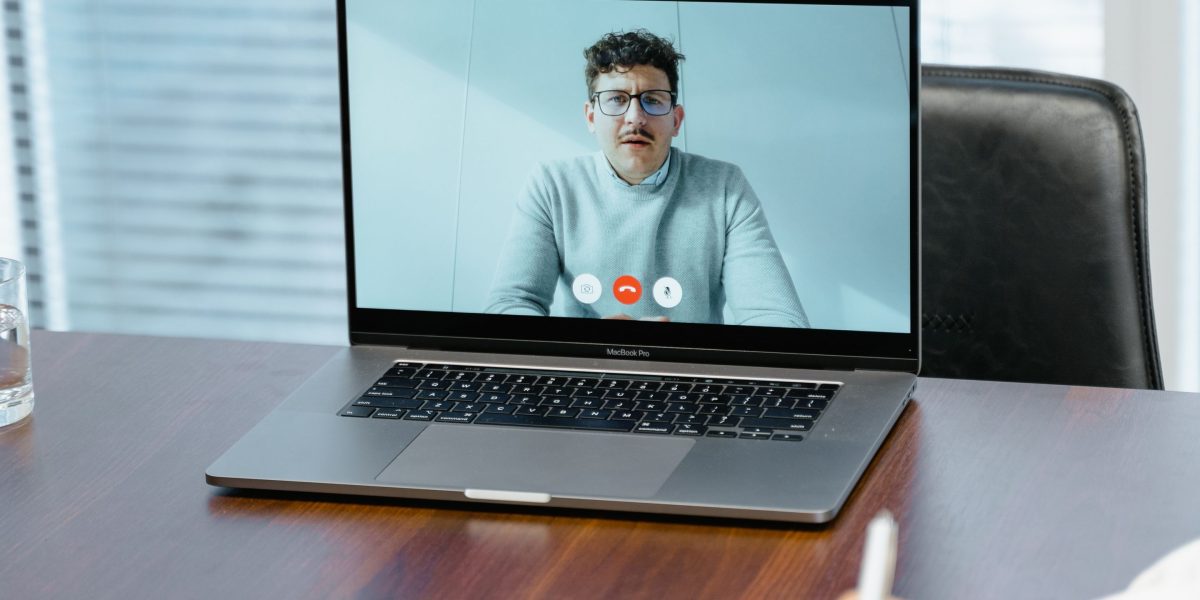 A confident professional participating in a virtual meeting, demonstrating effective remote communication skills.