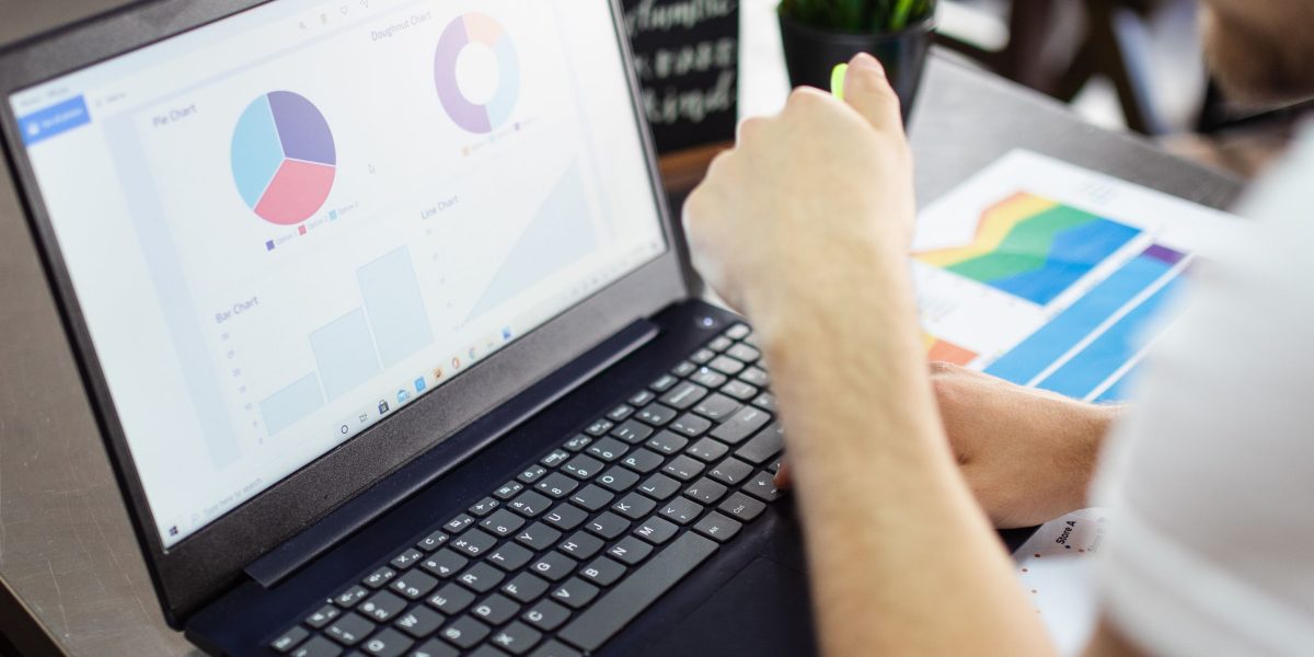 A person looking at various data sources, symbolizing the challenge of information overload in the AI investment landscape.