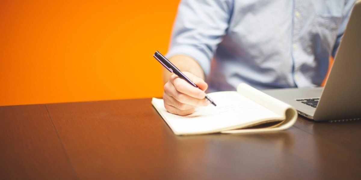 A businessperson actively strategizing at a whiteboard, reflecting the careful consideration of market patterns.
