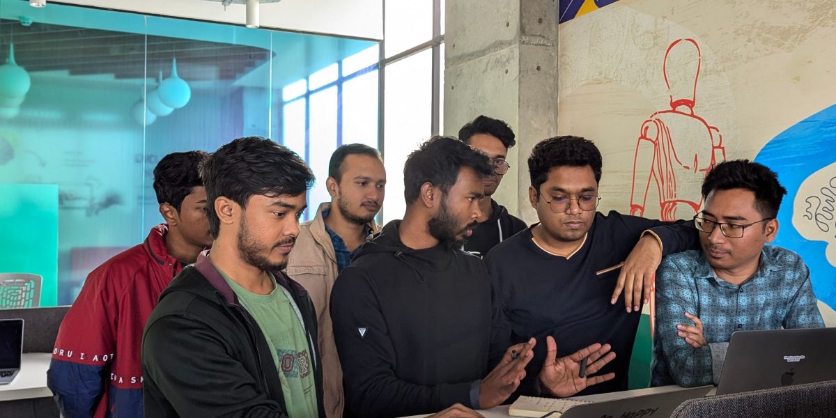 A team collaborating to test software, symbolizing the 'tech pilot' approach to AI adoption.