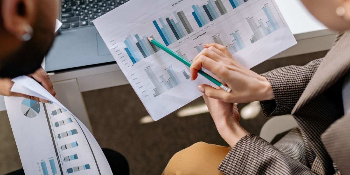 Professionals meticulously review detailed documents, symbolizing the thorough due diligence process for investments.