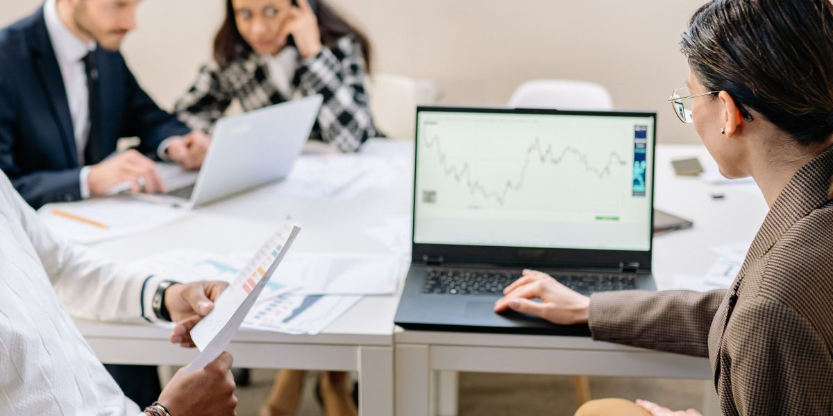 A professional team reviewing charts and data, representing the deep analysis of market signals for smart investing.