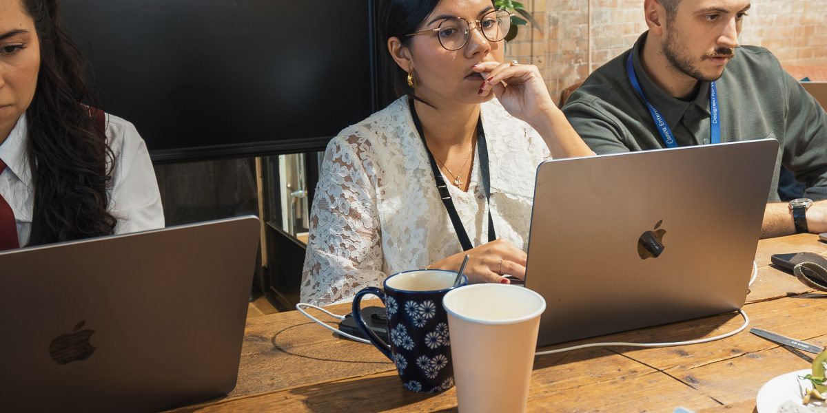 A diverse team collaborating and strategizing on integrating complex AI systems into existing business infrastructure.