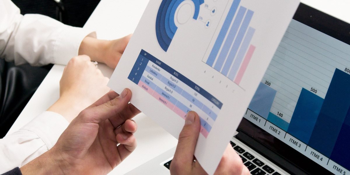 A person confidently presenting data analytics and positive business outcomes to a group, demonstrating success.