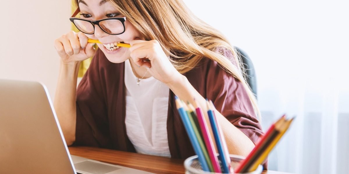 An individual focused on learning, actively engaging with an online course or educational material on a tablet or laptop.