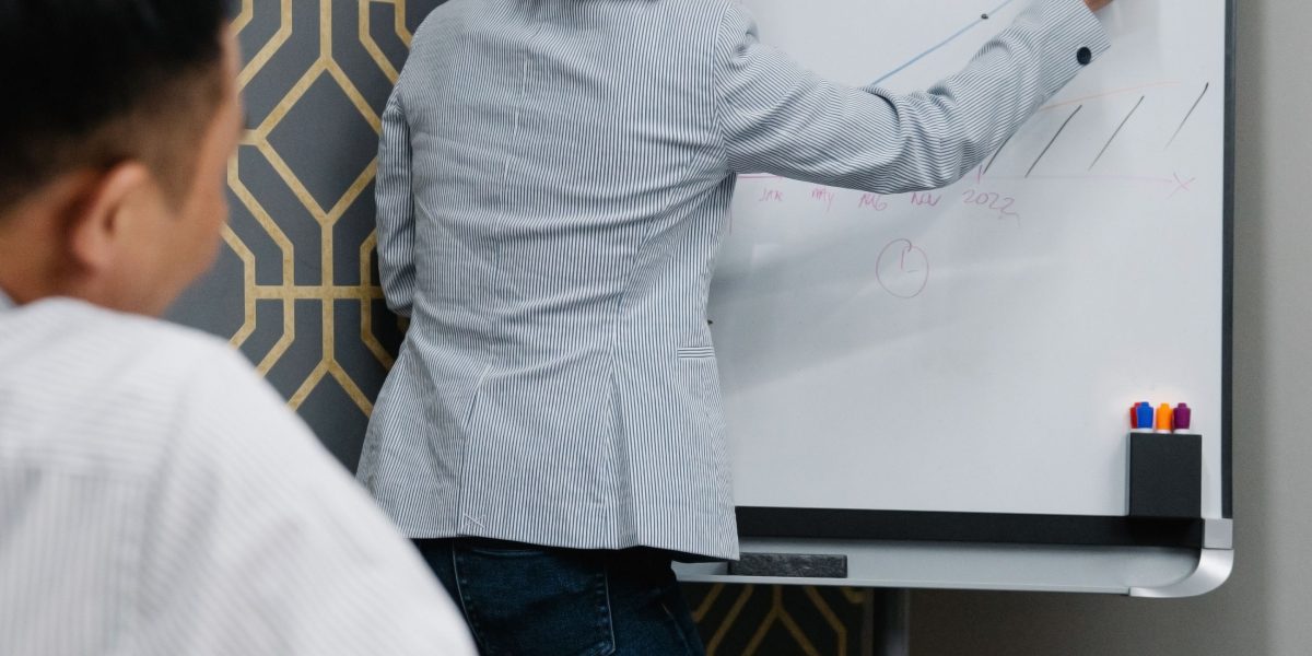 A diverse team collaborating around a whiteboard, outlining strategies and making key decisions for their business.