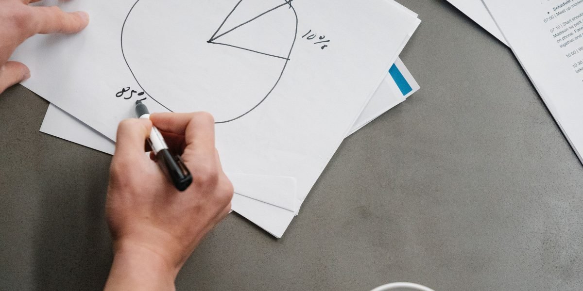 A person intently planning a new investment strategy, symbolizing a fresh approach to AI investing.