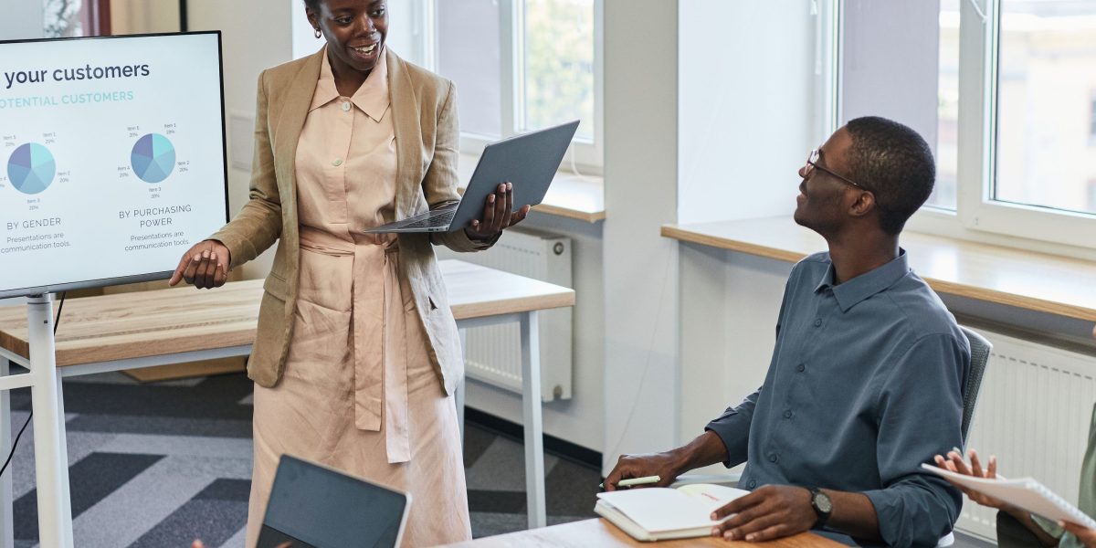 A confident professional delivering a business pitch, likely to potential investors, with clear communication.