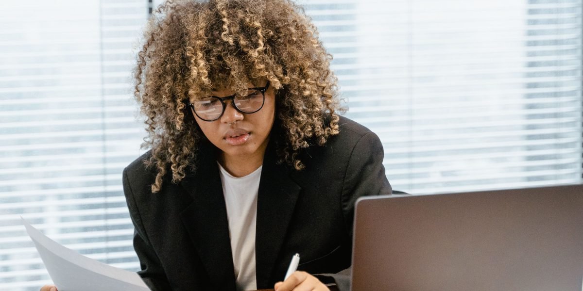 A person analyzes data on a dashboard, representing the use of tools and workflows to monitor legacy capital activity in AI.