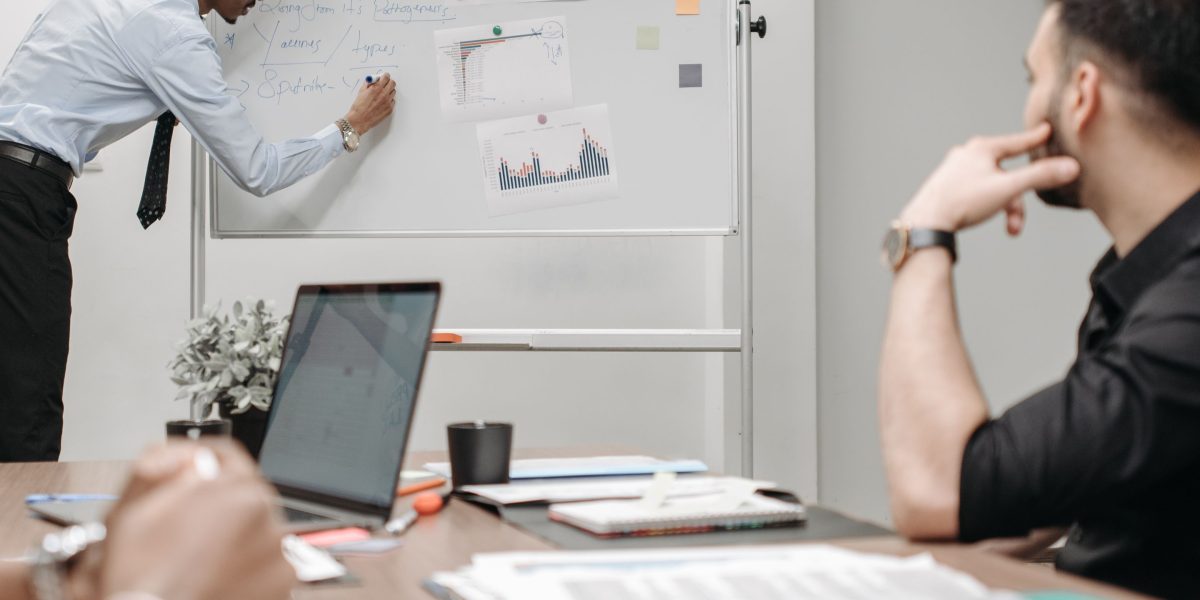 A team collaborates to understand and strategize based on emerging AI investment trends.