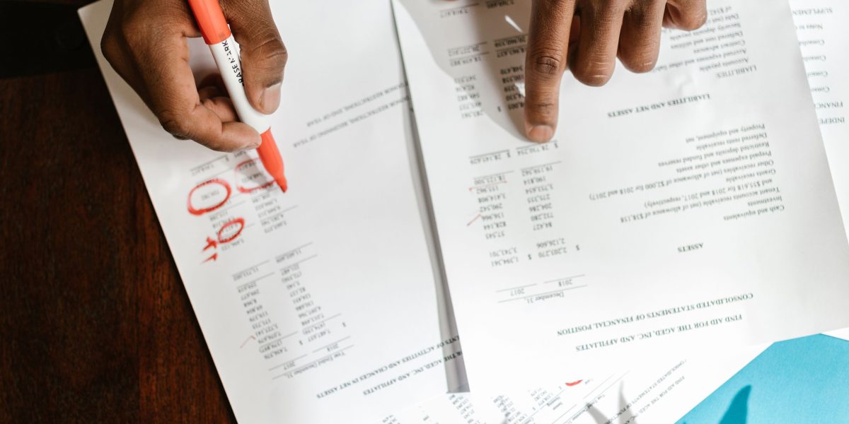An individual meticulously examining documents, representing the critical due diligence required to evaluate AI healthcare company claims and avoid potential red flags.
