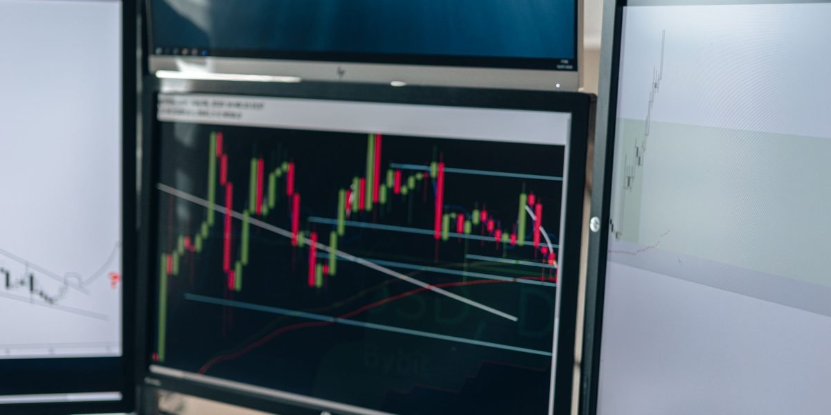 A professional thoughtfully reviewing market data to make informed decisions amidst complex information.