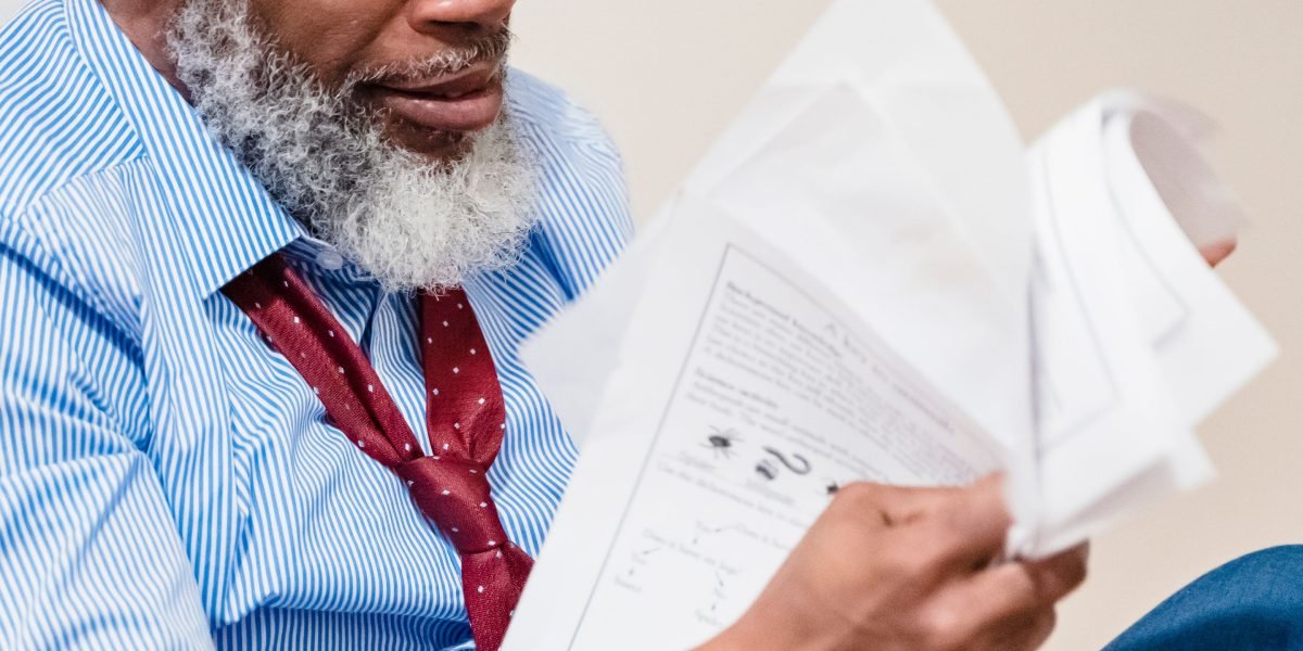 A person looking worried while reviewing financial documents, illustrating the personal liability risk in a general partnership.