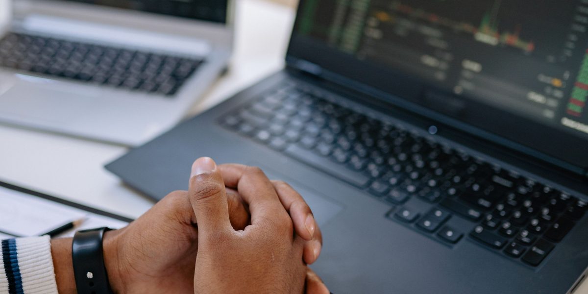 An individual reviewing data and charts on a screen to track investor behavior and market trends for AI companies.