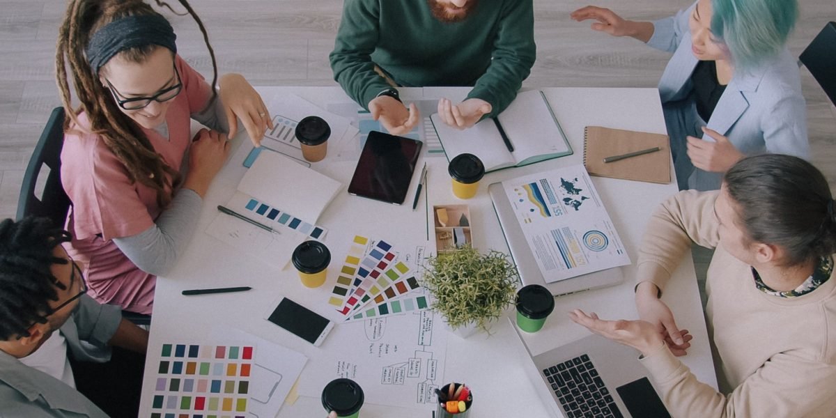 A group of diverse professionals actively collaborating, symbolizing innovation and efficiency in a modern workplace.
