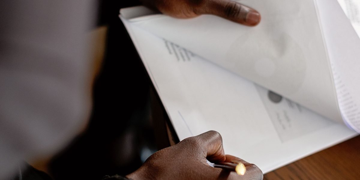 A professional meticulously reviewing brand guidelines documents, emphasizing consistency and attention to detail.